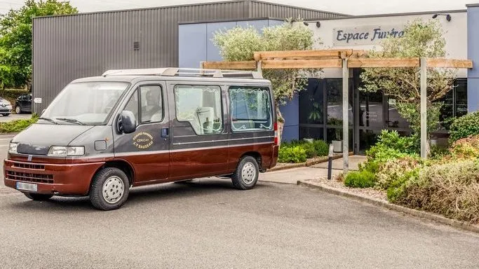 Véhicule de transport funéraire et corbillard devant la chambre funéraire